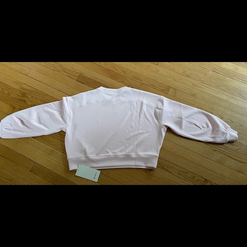 Brand new pink Lululemon crop sweatshirt. Never worn. With tags.